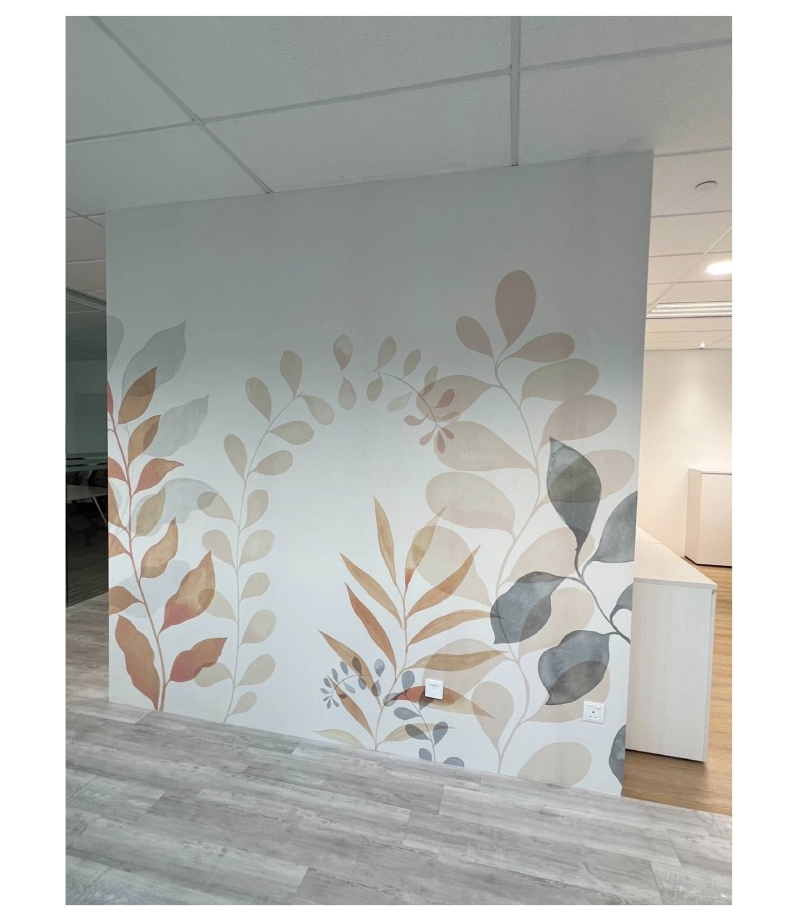 Botanical-themed wallpaper with soft pastel leaves in an office setting